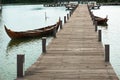 Traditional boats are leaning on a quiet dock. It`s boardwalk type dock Royalty Free Stock Photo