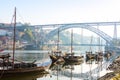 Traditional boats in the morning on river Douro with Porto city in the background, Portugal
