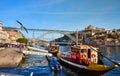 09 of December, 2018 - Porto, Portugal: Traditional boats with wine barrels on Douro river in old town with background of Dom Luis Royalty Free Stock Photo