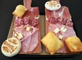 Traditional bolognese tray with typical products: tigelle, crescentine gnocco fritto, mortadella, salami and ham, Parmigiano Reg