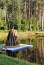 Traditional Bonfire Structure on a Floating Platform in a Forest Setting Royalty Free Stock Photo