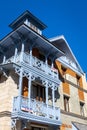 Traditional Borjomi building facade with blue carved wooden balcony in oriental style, Georgia.