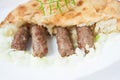 Traditional bosnian food cevapi with flat bread and onion