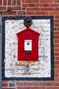 Traditional Game Well Boston fire alarm station box on an aloe brick wall in Boston, MA, USA