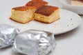 Traditional Brazilian dessert known as Bolo Gelado - Making step by step: Cake pieces wrapped and not wrapped in aluminum foil