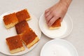 Traditional Brazilian dessert known as BOLO GELADO in Portuguese - Making step by step: Hand putting piece of cake in milk Royalty Free Stock Photo