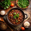 Traditional Brazilian feijoada served on rustic table with side plates rice and garnishes Royalty Free Stock Photo