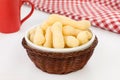 Traditional Brazilian starch biscuit called biscoito de polvilho in a basket in a white background coffe table