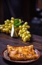 Traditional bread pita or khachapuri on the table with herbs. Homemade baking recipe Royalty Free Stock Photo