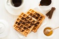 Traditional breakfast: coffee, belgian waffles with honey and chocolate sauce Royalty Free Stock Photo