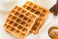 Traditional breakfast: coffee, belgian waffles with honey and chocolate sauce Royalty Free Stock Photo