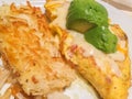 Traditional breakfast: omelet with avocado and hash brown Royalty Free Stock Photo