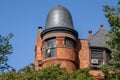 Traditional brick building with an ornate cast iron tower adorning the top in New York City, USA.