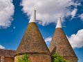 Traditional brick built oast houses with white chimneys in Kent, UK. Taken on a sunny day with blue sky in summer