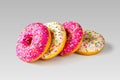 Traditional bright American doughnuts on a light gray background