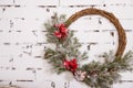 A traditional bright Christmas wreath hanging over the fireplace, on a white brick wall.Christmas concept, new year Royalty Free Stock Photo