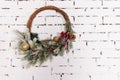 A traditional bright Christmas wreath hanging over the fireplace, on a white brick wall.Christmas concept, new year Royalty Free Stock Photo