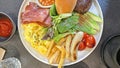 Traditional British all day breakfast dish, sausage, bacon, mushroom, tomato, bread, egg, fries and vegetable Royalty Free Stock Photo