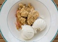 Traditional british apple crumble pie in dish with ice cream Royalty Free Stock Photo