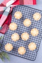 Traditional British Christmas mince pies with fruit filling, on cooling rack, vertical, top view Royalty Free Stock Photo