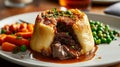 Traditional British dish steak and kidney pudding in suet pastry with gravy served on a plate. Delicious hearty comfort food Royalty Free Stock Photo