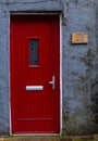 Traditional English house facade front entrance with red closed door . Royalty Free Stock Photo