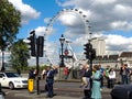 Traditional British people and tourists in Westminster crossing the street in a typical busy day in London