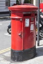 Traditional british red pillar box, free-standing post box on the street, London, United Kingdom