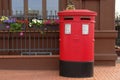Traditional british red post box on street. Royalty Free Stock Photo