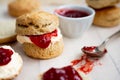 Close up of scones with clotted cream and strawberry jam Royalty Free Stock Photo