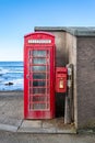 Traditional British Telecom red phone box next to an old post box in Pennan, Aberdeenshire, Scotland Royalty Free Stock Photo