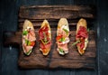 Traditional Bruschetta with Parma dried ham and prosciutto. Italian antipasti set sandwiches with jamon Royalty Free Stock Photo