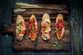 Traditional Bruschetta with Parma dried ham and prosciutto. Italian antipasti set sandwiches with jamon Royalty Free Stock Photo