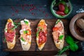 Traditional Bruschetta set with Parma dried ham and prosciutto. Italian antipasti  sandwiches with jamon Royalty Free Stock Photo