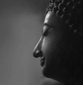 Traditional Buddha head against a black background with copy space. Royalty Free Stock Photo