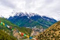 Traditional buddhist prayer flags over foggy mountain background in Ngawal, Nepal