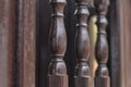 Three wooden fence pillars patterned in dark brown