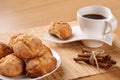 Traditional bulgarian cookies, called kurabiiki, cup of coffee and tied cinnamon sticks on a beige bamboo table mat. Shallow depth Royalty Free Stock Photo