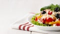 Traditional Bulgarian dish, Shopsky salad, with vegetables and cheese, on a white background, no people, horizontal,