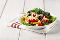 Traditional Bulgarian dish, Shopsky salad, with vegetables and cheese, on a white background, no people, horizontal,