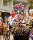 Traditional Bulgarian kuker man with his giant colorful evil mask