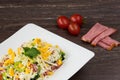 Traditional Bulgarian Shepherd salad with tomatoes, peppers, cucumbers, mushrooms, ham, cheese and eggs in white dish Royalty Free Stock Photo