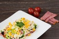 Traditional Bulgarian Shepherd salad with tomatoes, peppers, cucumbers, mushrooms, ham, cheese and eggs in white dish. Royalty Free Stock Photo