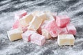 Traditional bulgarian turkish delight lokum, ordinary and rose flavoured, on black board with powederd sugar Royalty Free Stock Photo