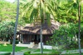 Traditional Bungalow in the Asian garden. Exotic plants and flowers, beautiful landscape. Royalty Free Stock Photo