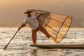 Traditional Burmese fishermen with fishing net at Inle lake in Myanmar famous for their distinctive one legged rowing style, Royalty Free Stock Photo