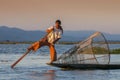 Traditional Burmese fishermen with fishing net at Inle lake in Myanmar famous for their distinctive one legged rowing style, Royalty Free Stock Photo