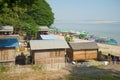 Traditional Burmese houses on the bank of the Irrawaddy river. Mingun, Myanmar