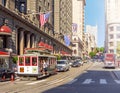 Traditional Cable Car loaded with tourists moves in city traffic near Union Square in San Francisco Royalty Free Stock Photo