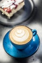 Traditional cappucino coffee with cake on cafe table Royalty Free Stock Photo